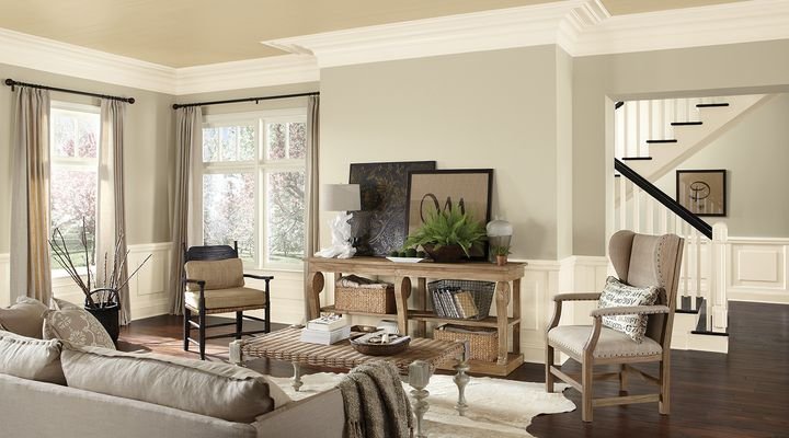 Living room with warm greige walls, white wainscoting and crown molding