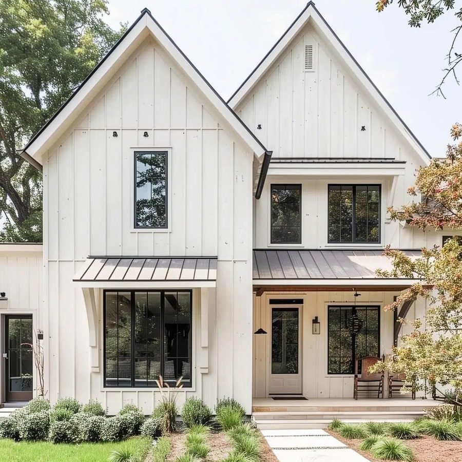 White board-and-batten farmhouse with black windows